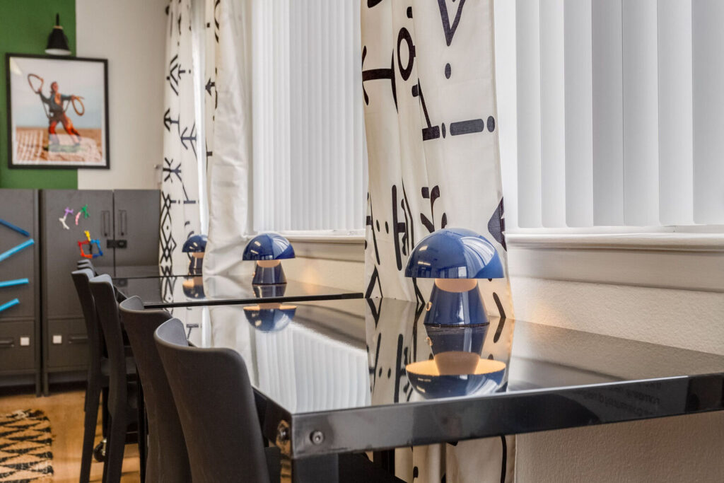 Kids club with desks and chairs, large windows, and shelves with books and games