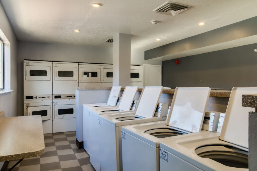 laundry facilities with several washers and dryers