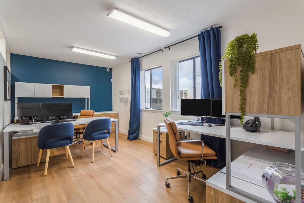 Leasing office with desks and chairs and large windows
