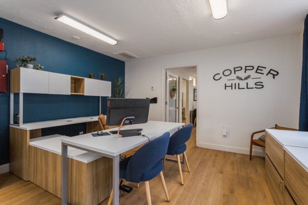 Leasing office with desks and chairs and large windows