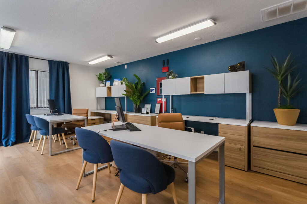 Leasing office with desks and chairs and large windows