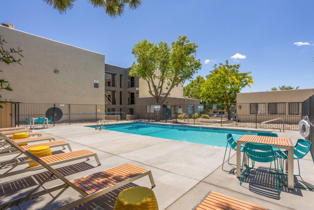 Pool with deck and chairs at Copper Hills apartments in Albuquerque
